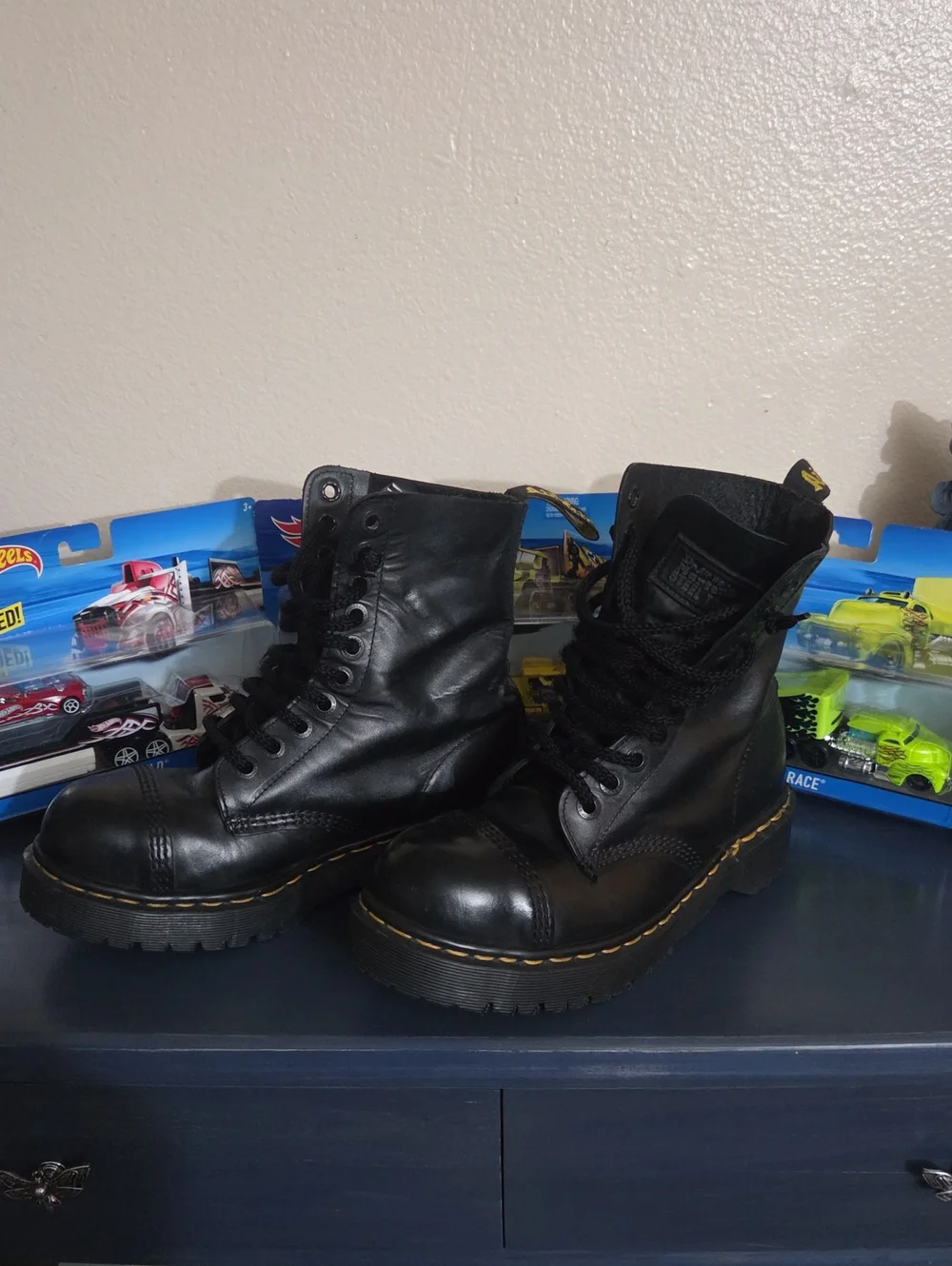 Dr. Martens steel toe black leather lace-up combat boots.